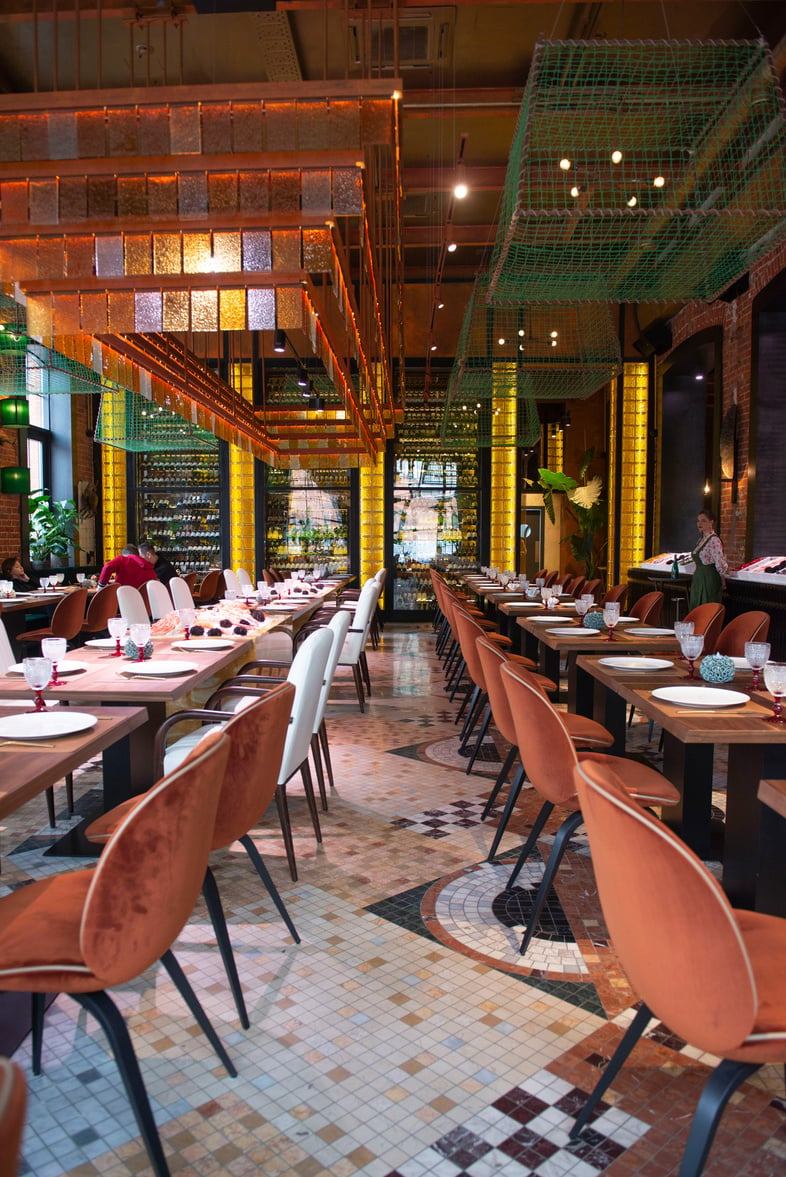 People Sitting on Chairs Inside Restaurant